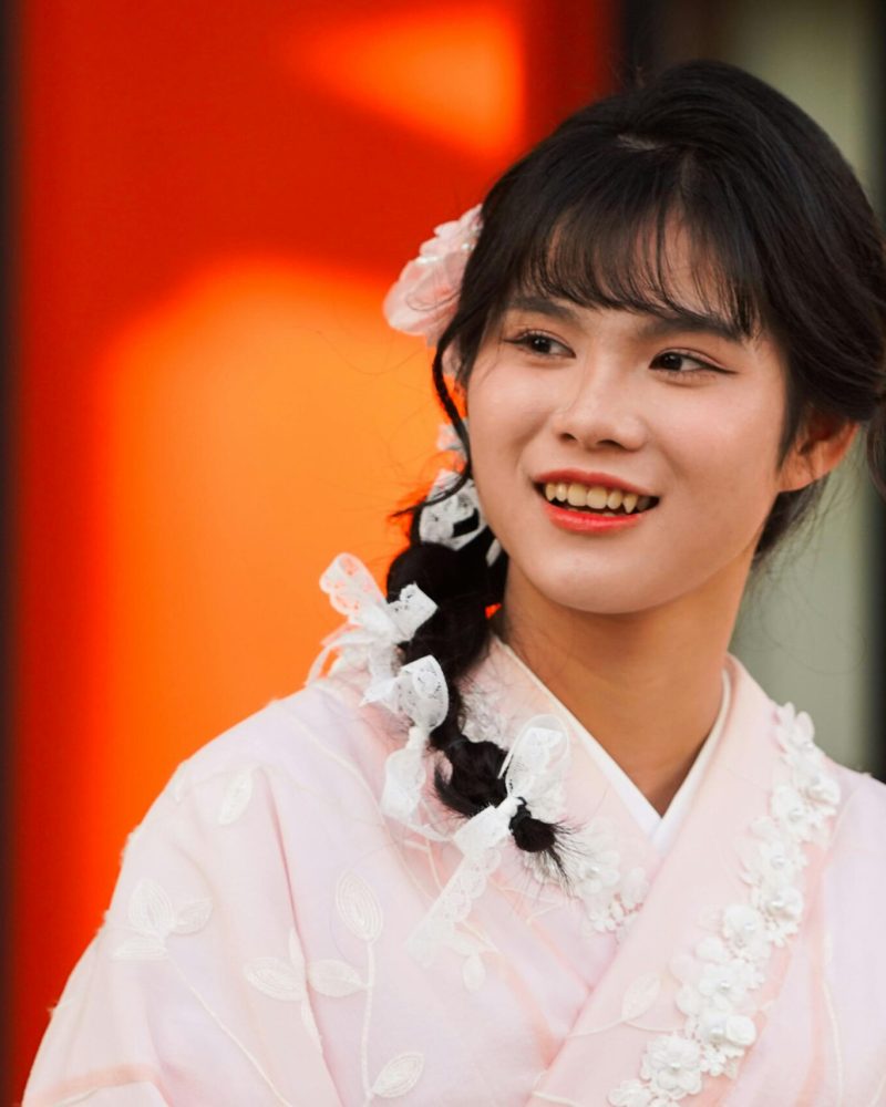 Portrait of a young woman in a pink kimono in Kyoto, Japan.
