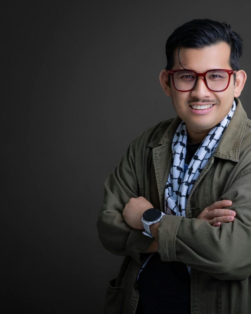 Portrait of an adult male in Tanjung Tokong, Penang, wearing a jacket and kuffiyeh. Studio photography.